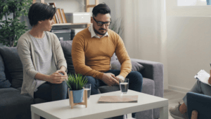 couple sitting apart in a quiet space feeling emotionally distant