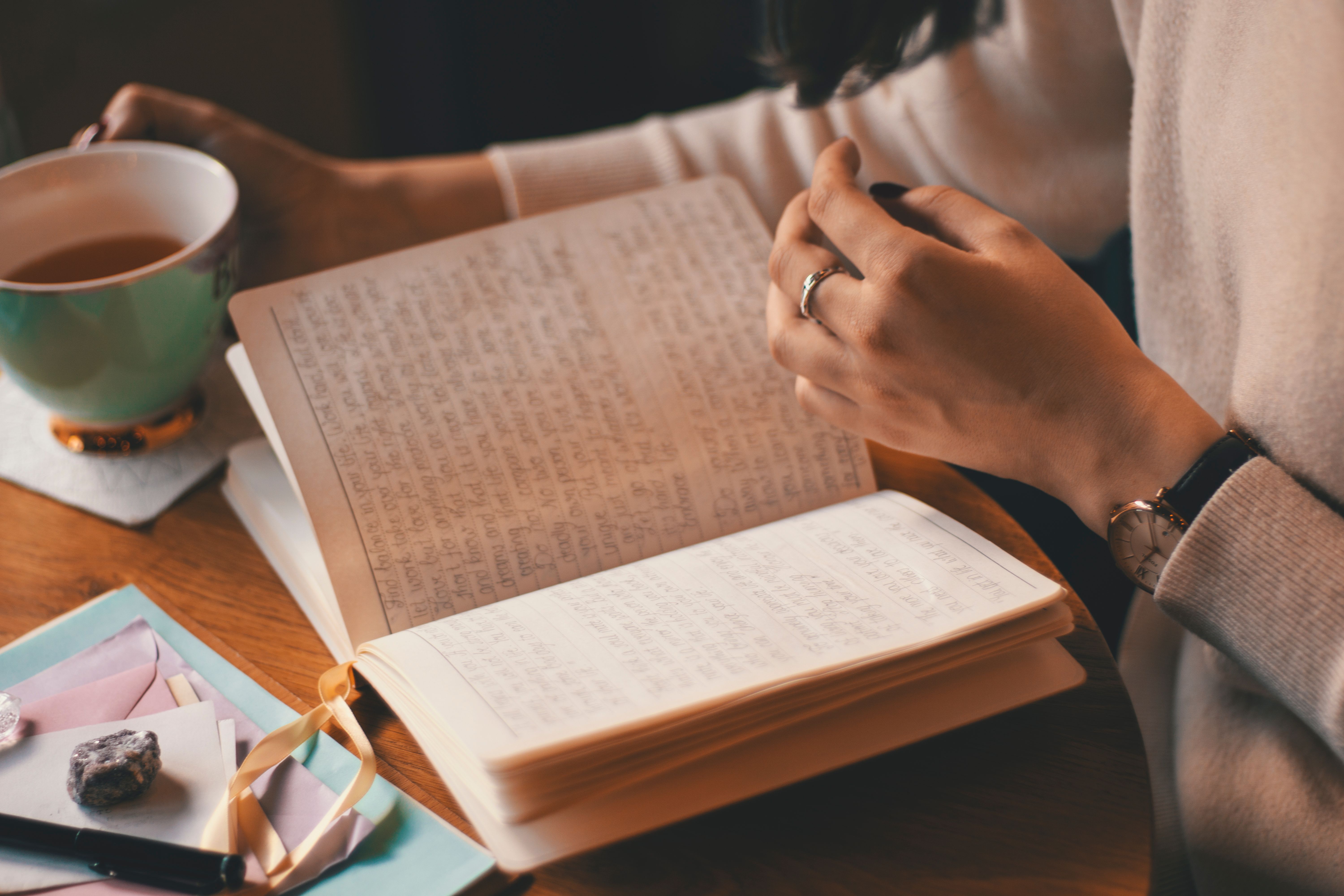 Person writing thoughts in a journal for mental wellness